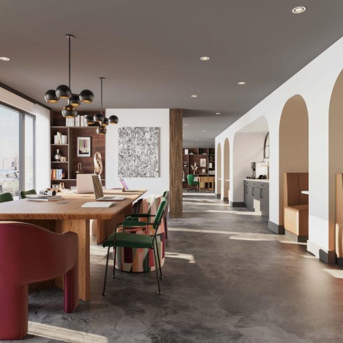 a work room with a table chairs and booths