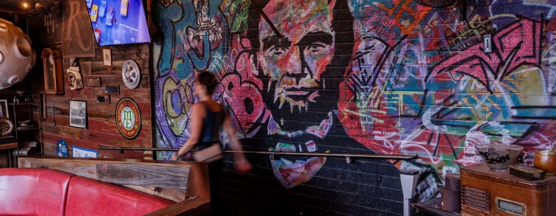 Women walking in front of Lincoln mural at Rebar