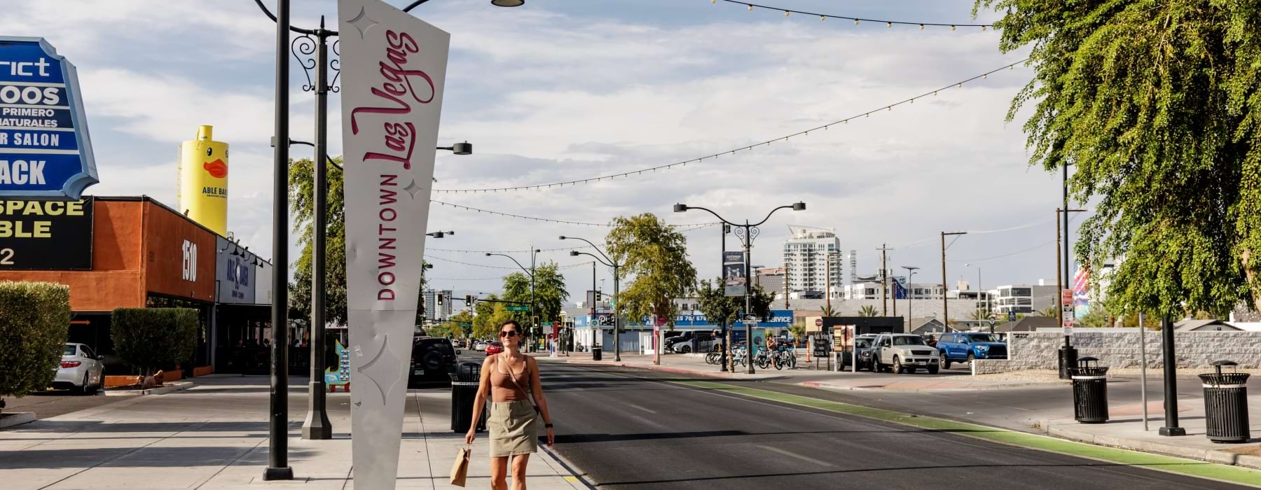 Woman Walking by Sign