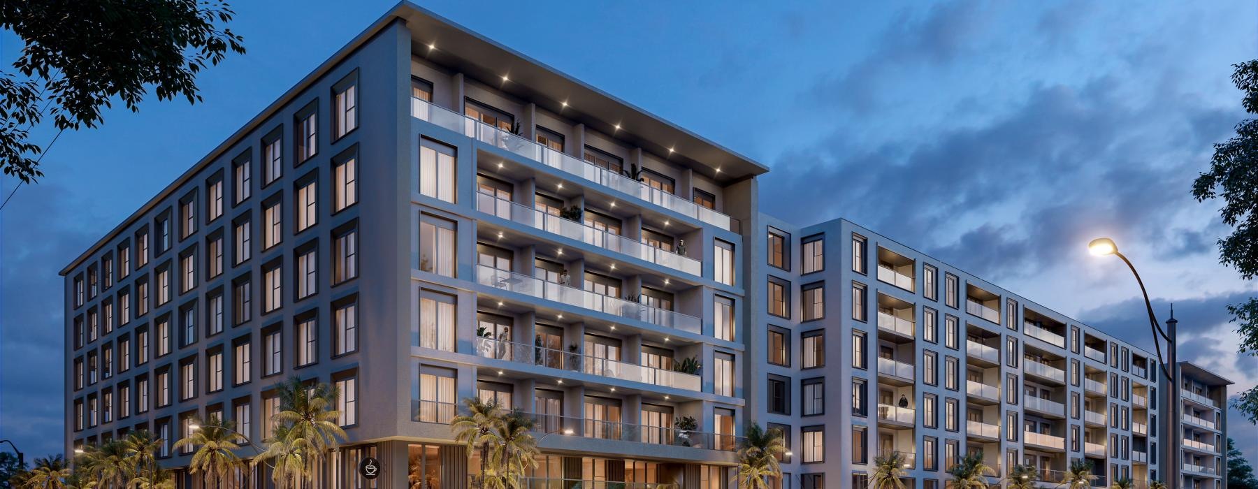 a building at night with cars parked in front