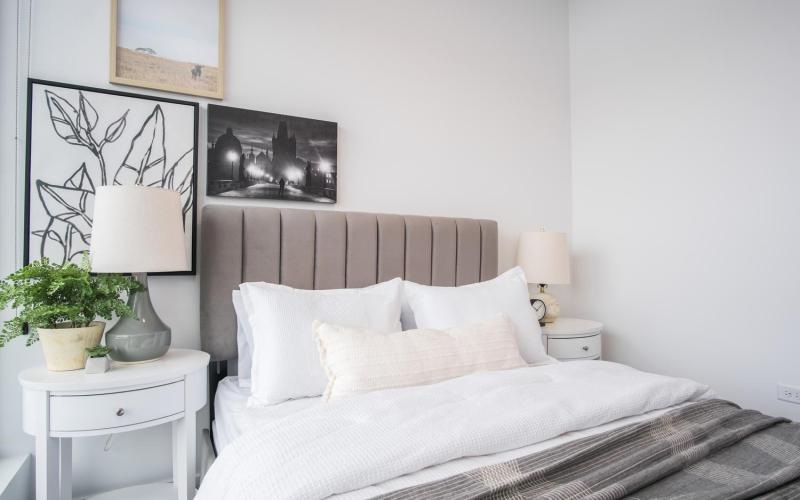 a bedroom with a bed with white pillows