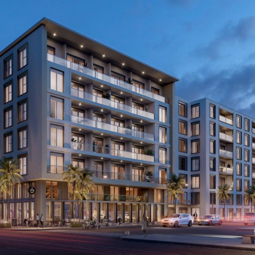 a building at night with cars parked in front